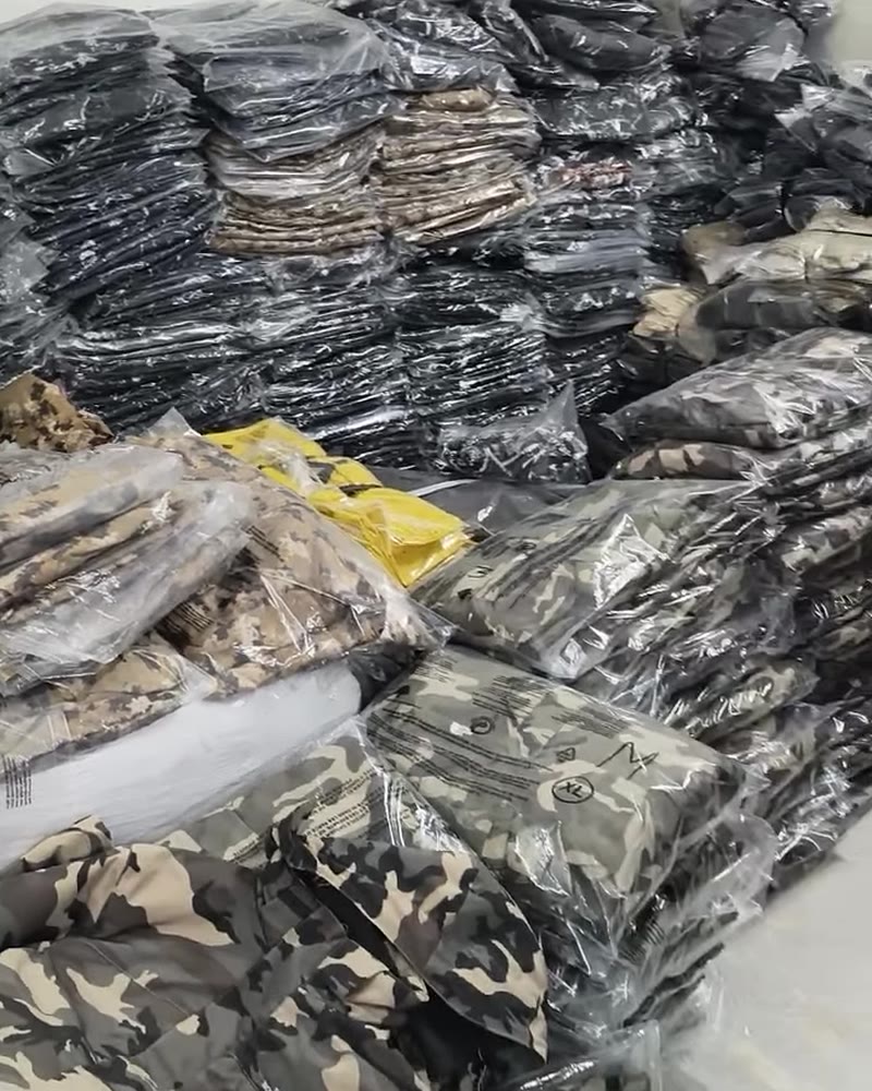 Stacks of packed camo and printed jackets in the YS Hill stockroom